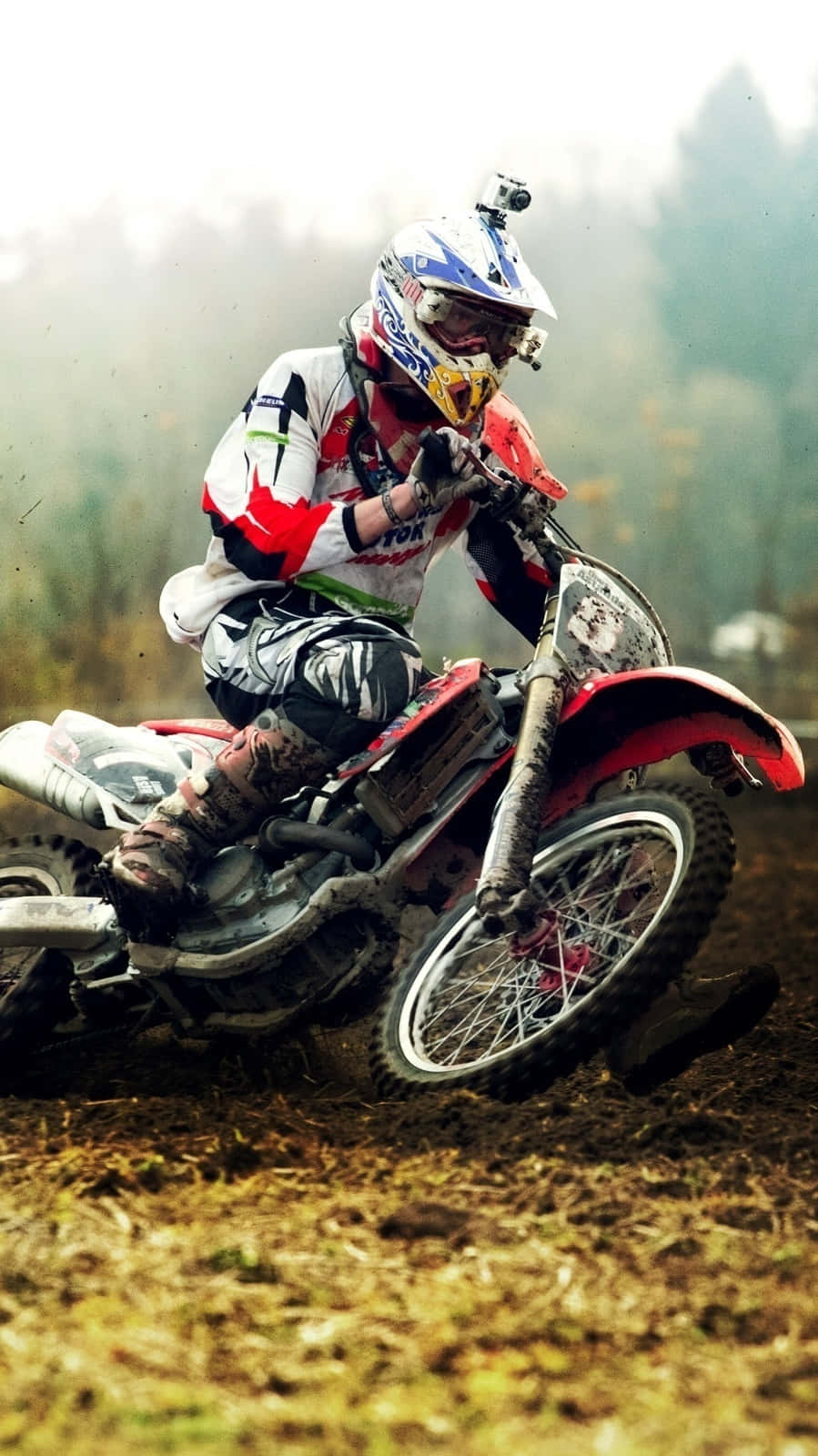 Caption: Thrilling Ride Through The Mud - Motocross Rider In Action Wallpaper