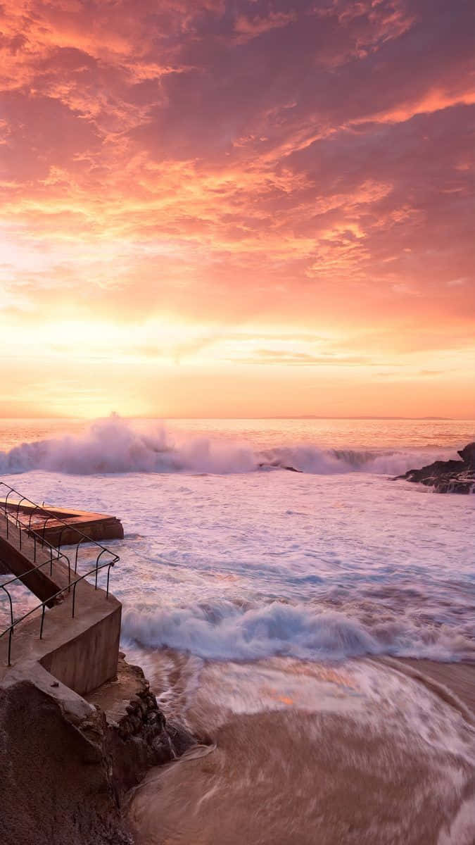 Capture The Perfect Sunset Moment With This Beautiful Beach Scene Wallpaper