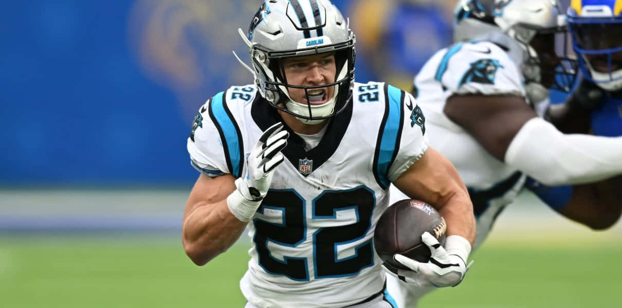 Carolina Panthers Running Back Christian Mccaffrey Rushes For A Touchdown During An Nfl Game. Wallpaper