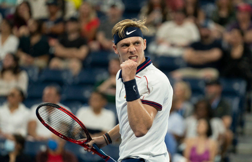 Celebratory Moment Of Denis Shapovalov On Tennis Court Wallpaper