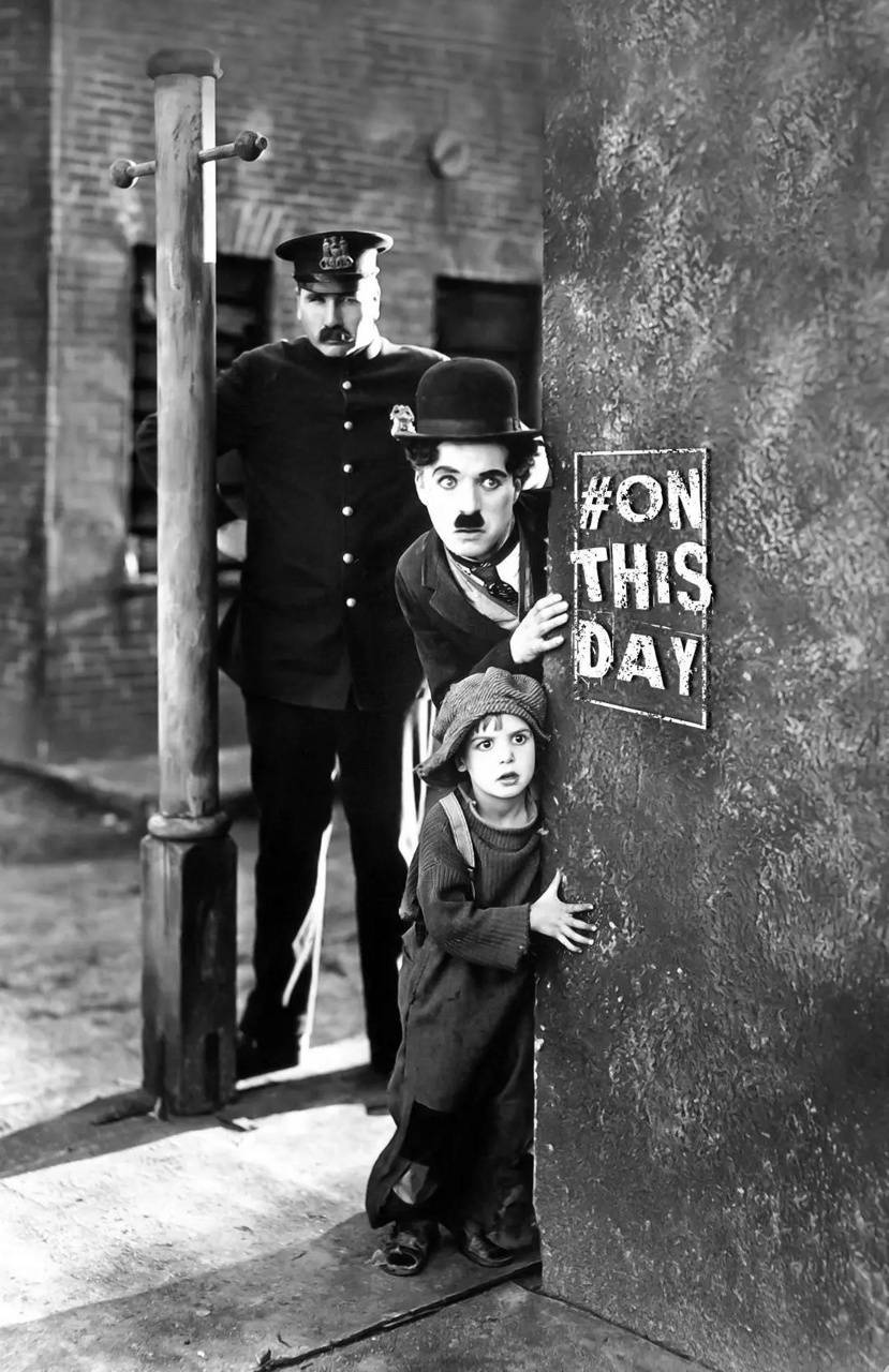 Charlie Chaplin And Kid Peeking Wallpaper