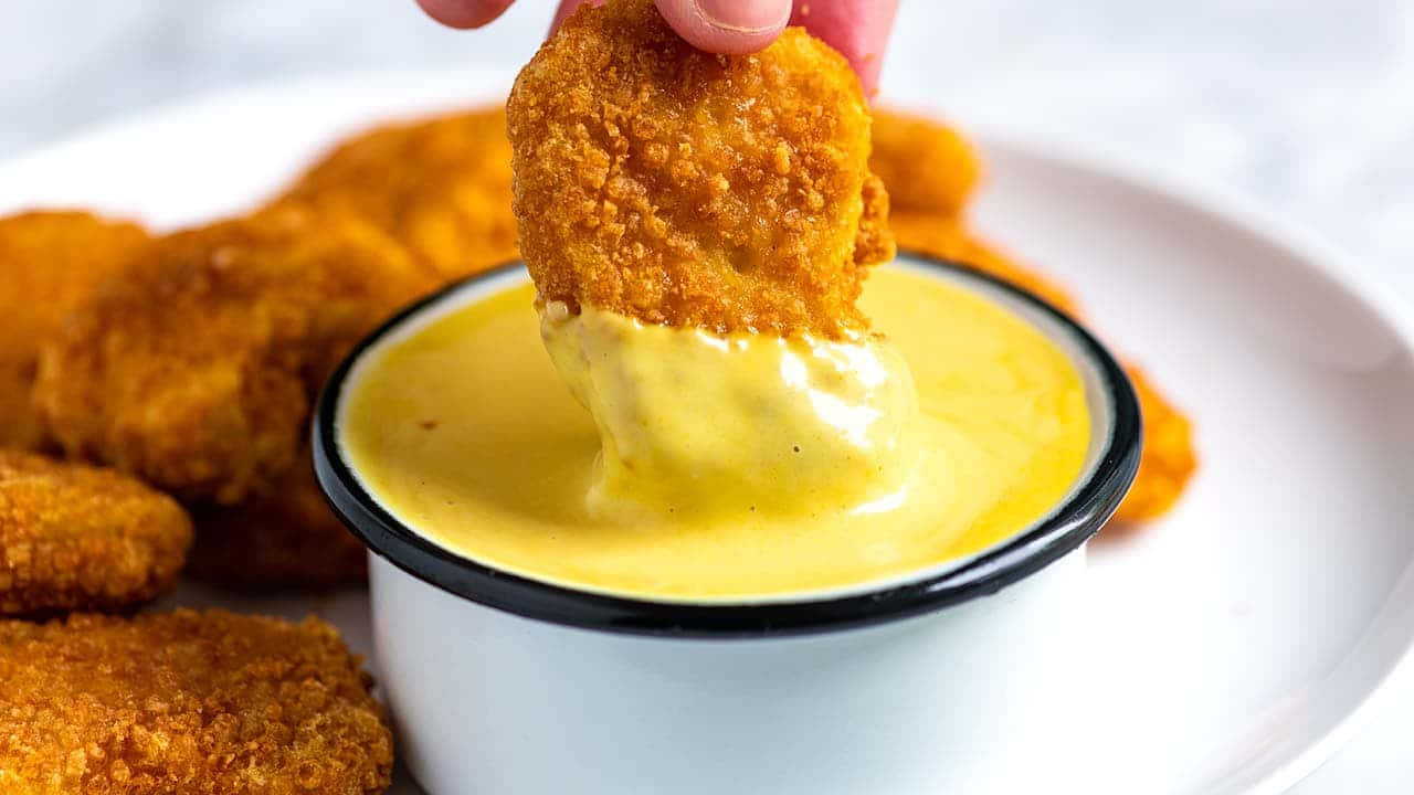 Chicken Nugget Dippingin Mustard Sauce Wallpaper