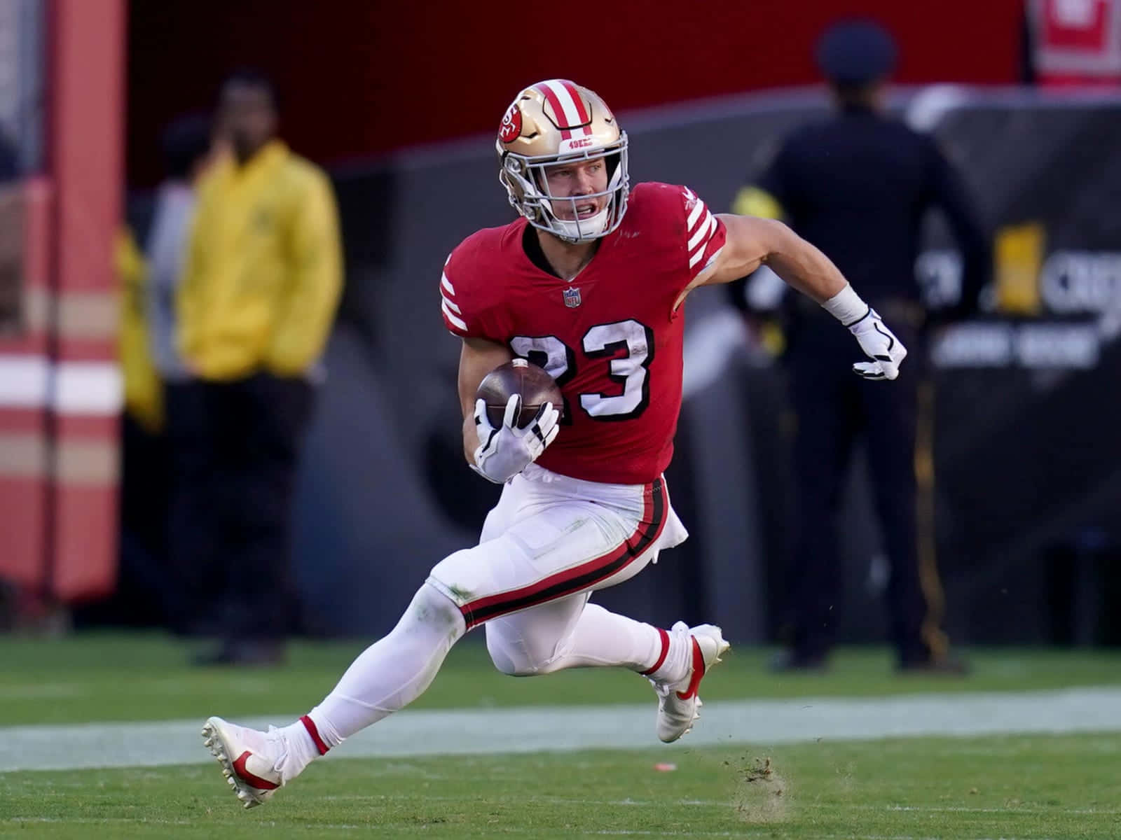 Christian Mccaffrey Running Towards His Next Touchdown Wallpaper