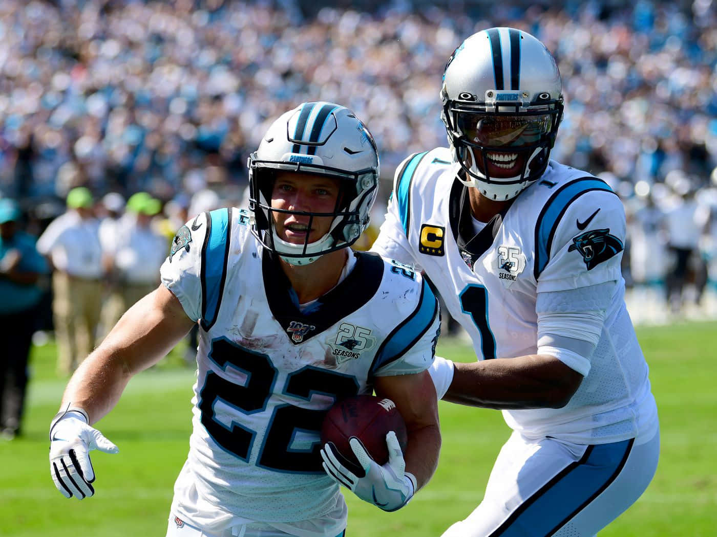 Christian Mccaffrey Surrounded By Carolina Panthers Cheerleaders Wallpaper