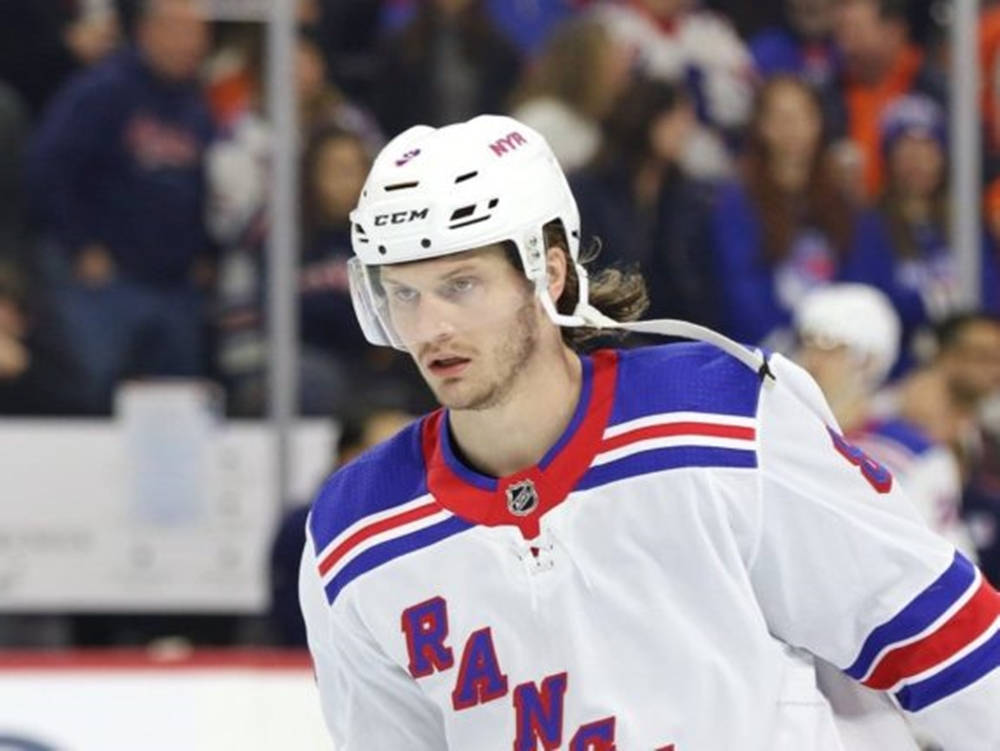 Close Up Look Of Jacob Trouba With Serious Expression During Game Wallpaper