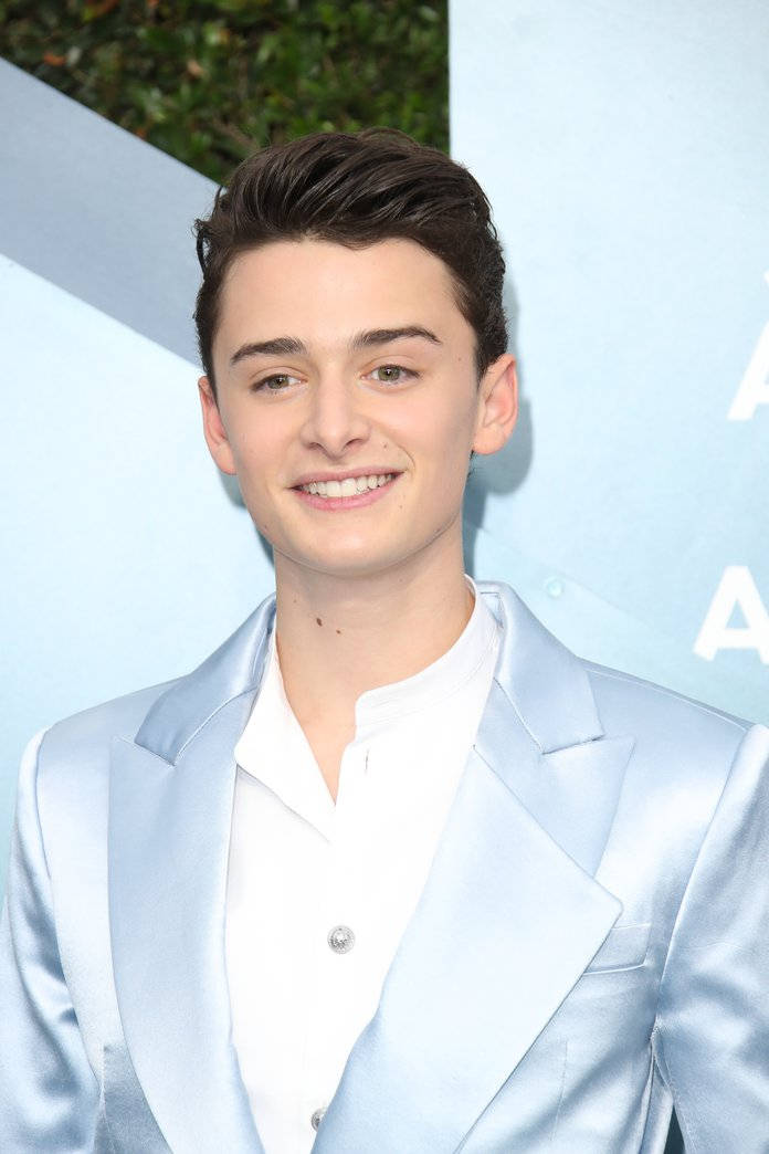 Closeup Noah Schnapp Wearing Dusty Blue Suit Wallpaper