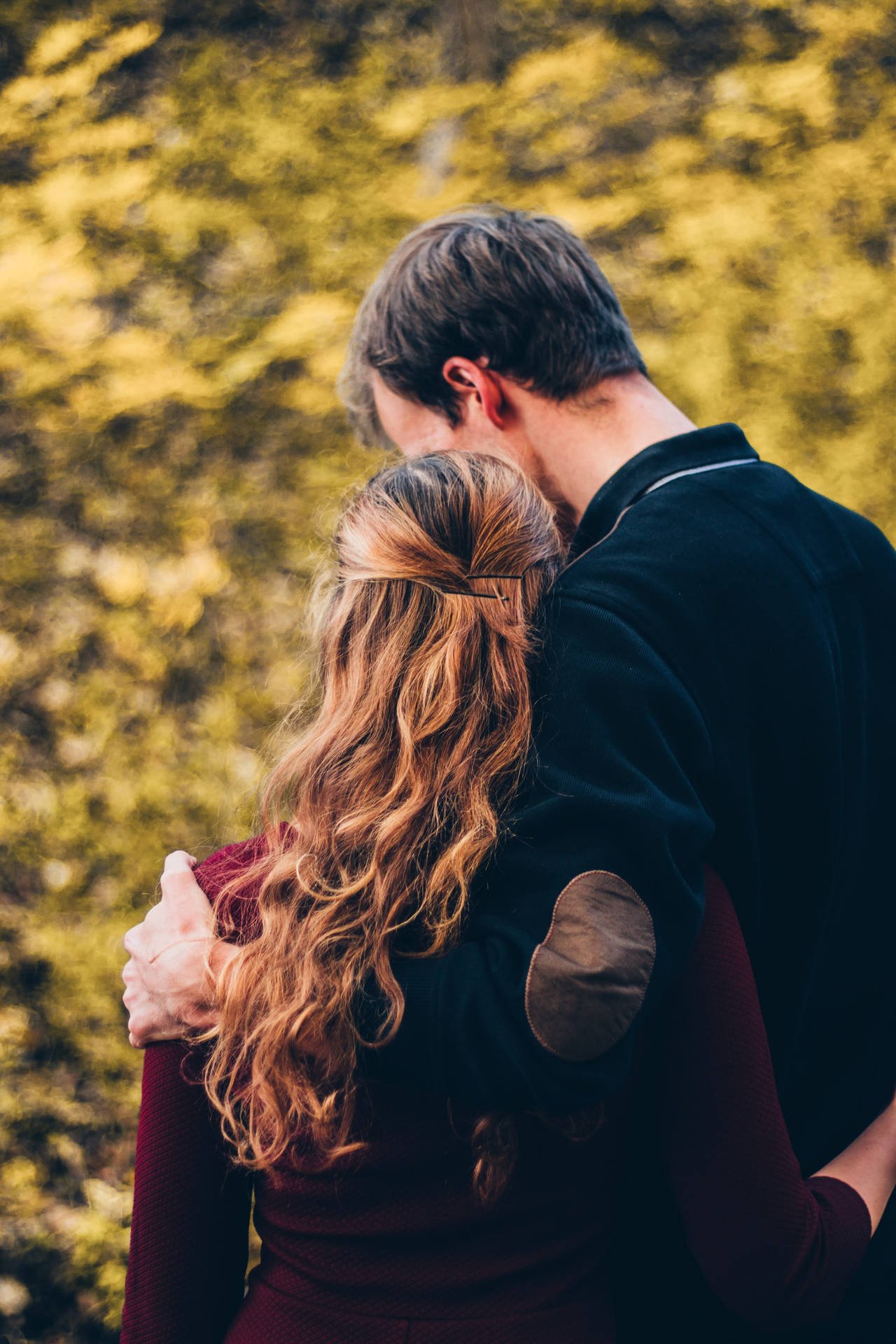 Couple Hugging In Bokeh Backdrop Wallpaper