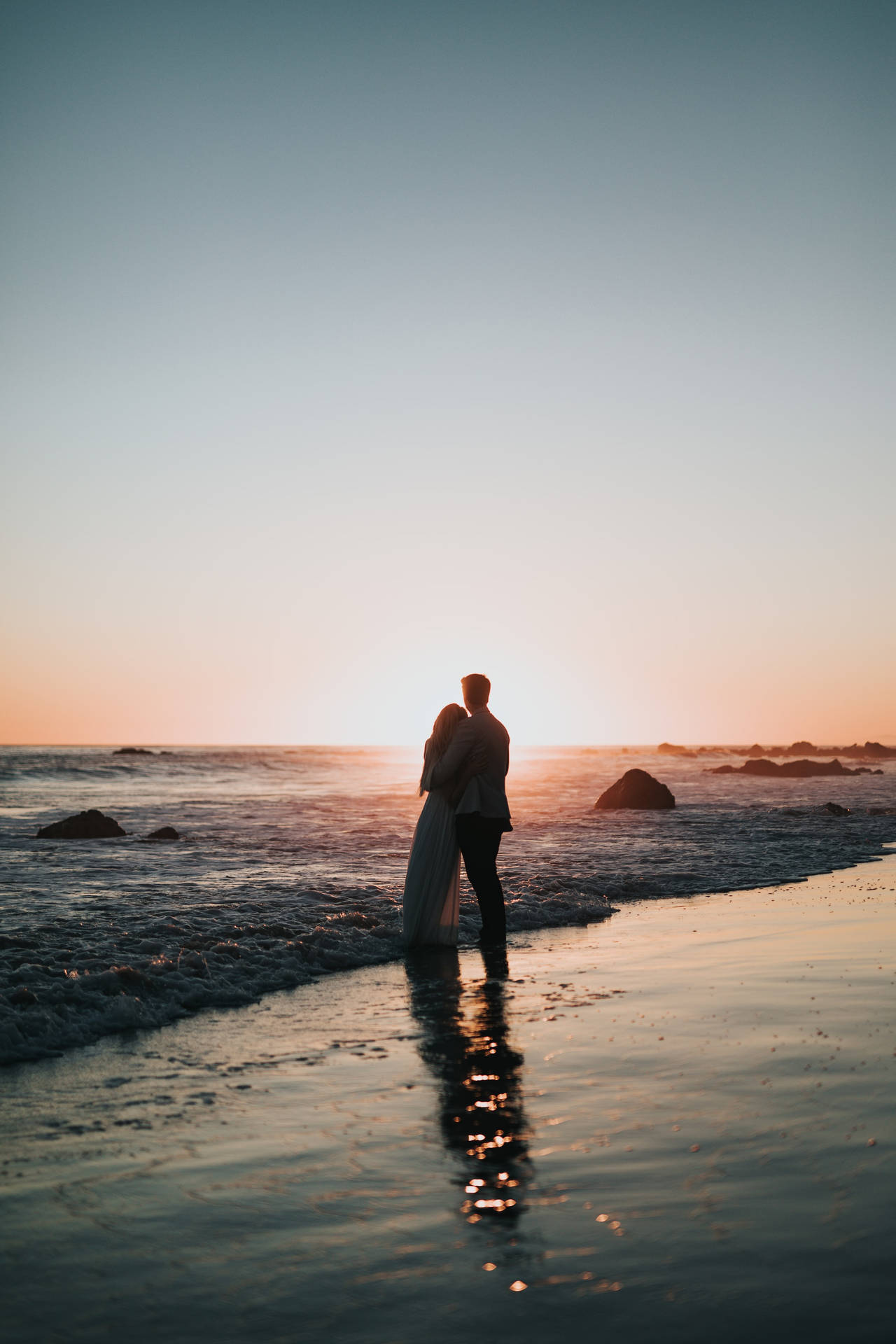 Couple Hugging On The Beach Wallpaper