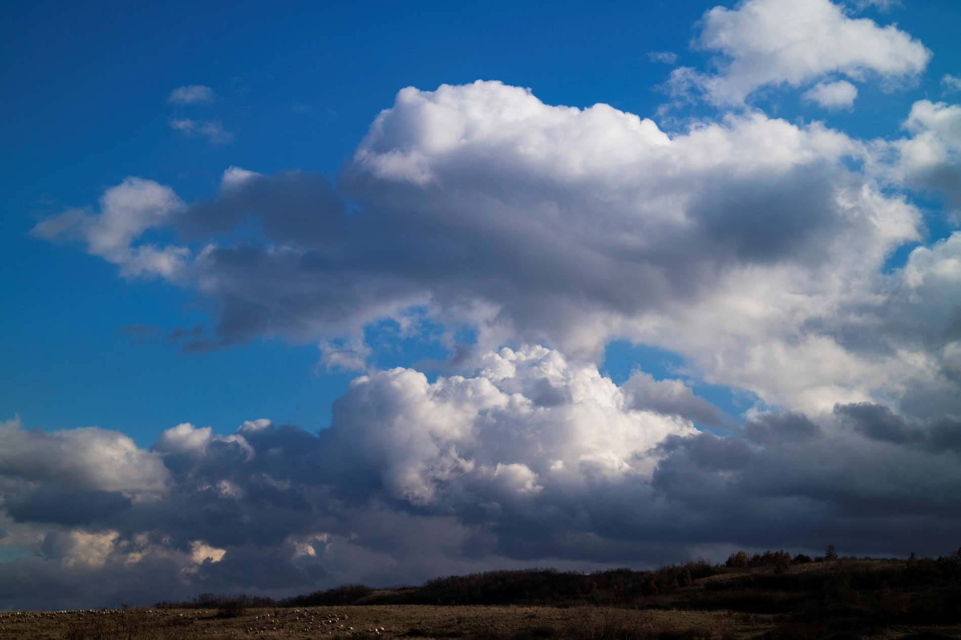 Cumulus Clouds And Hills Horizon Wallpaper