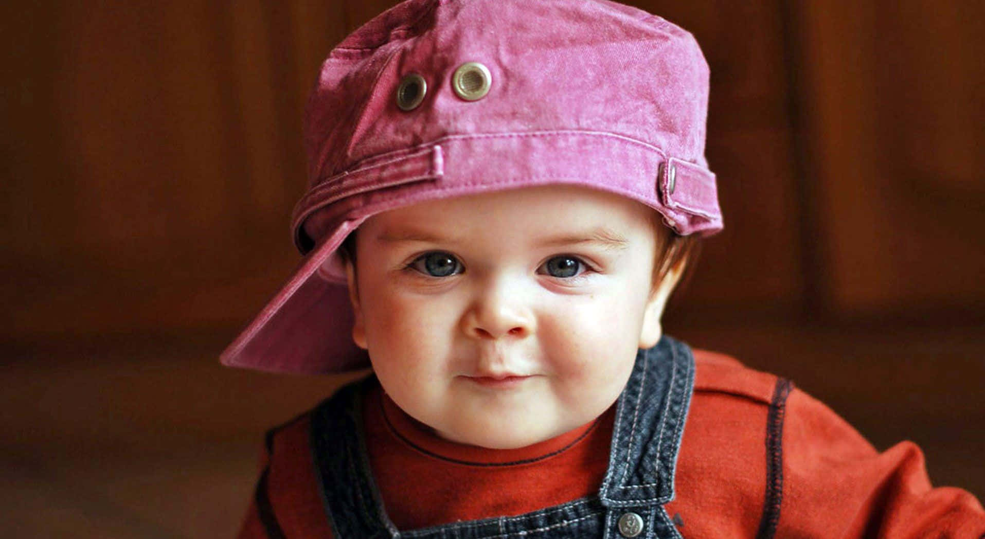 Cute Baby Wearing A Cap Wallpaper