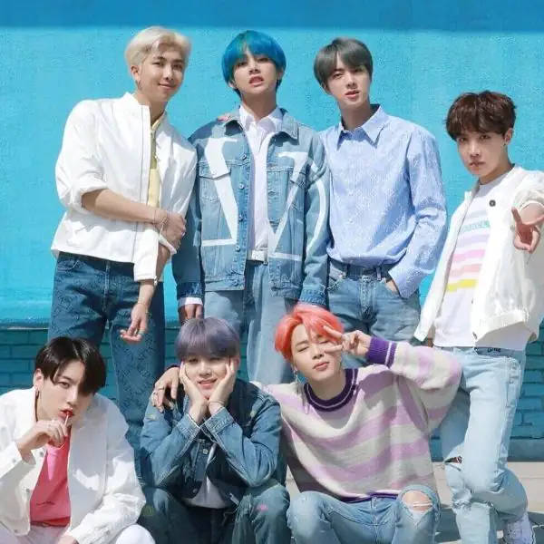 Cute Bts Group Poses Together On A Blue Wall Wallpaper