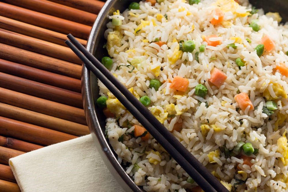 Delicious Fried Rice Served With Chopsticks Wallpaper