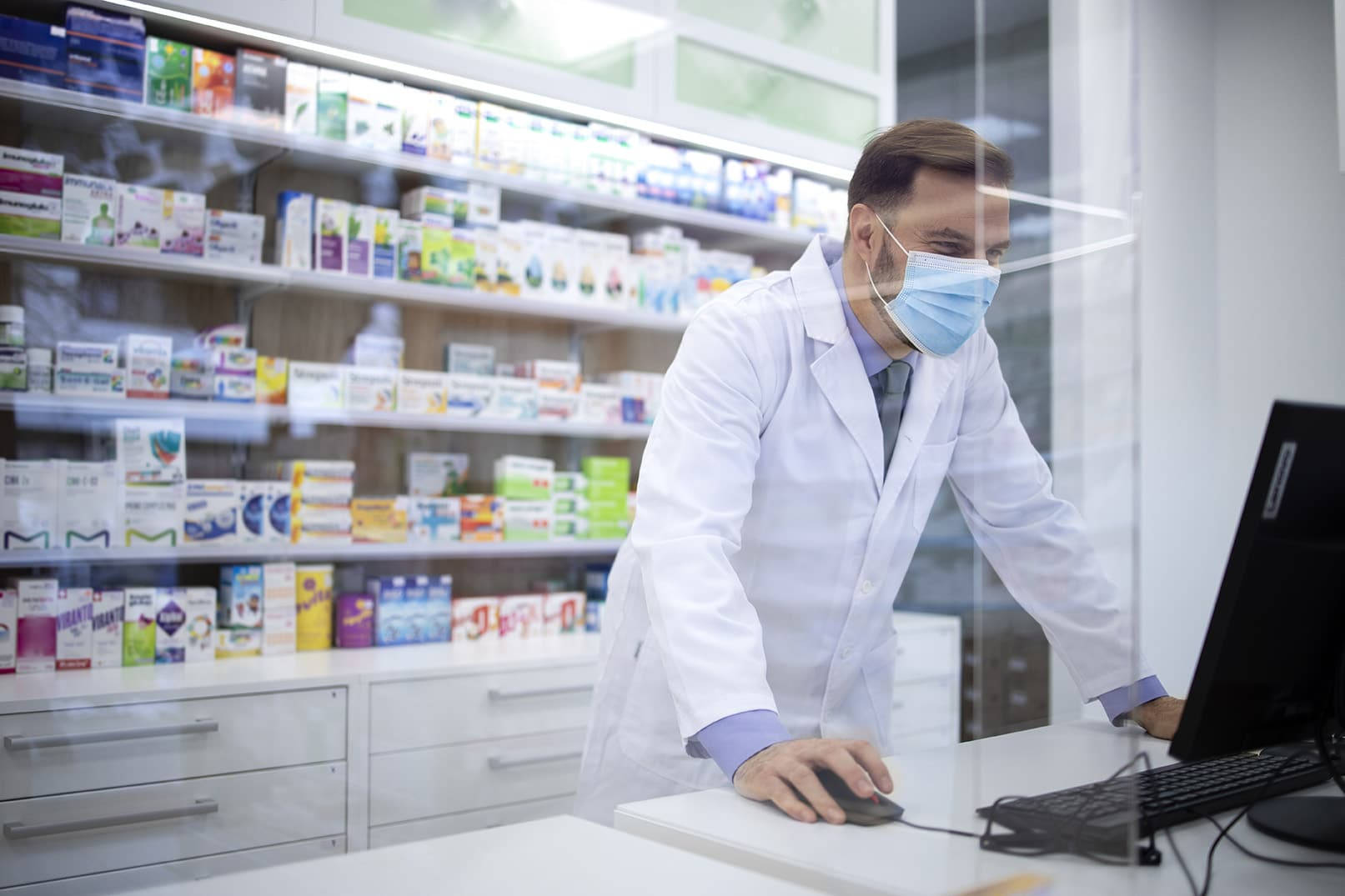 Diligent Pharmacist At Work During Pandemic Wallpaper