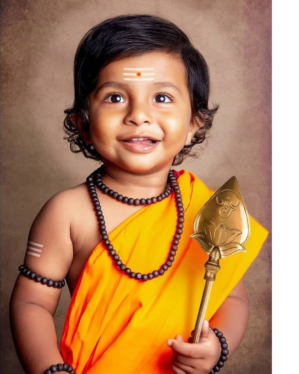 Divine Baby Murugan Clothed In Radiance And Golden Veera Vel Wallpaper