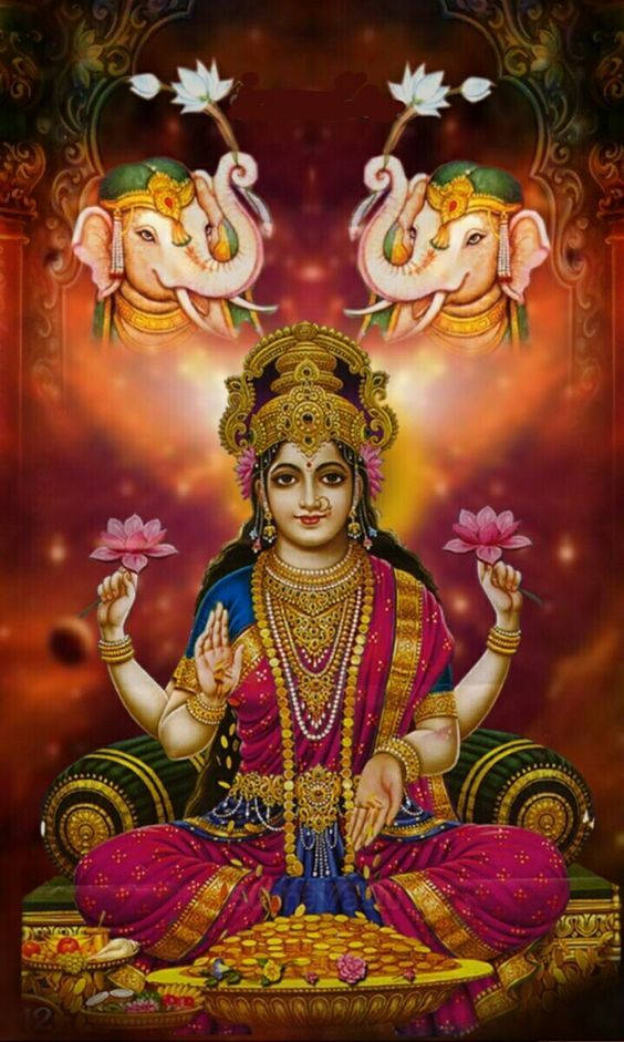Divine Lakshmi Adorned By Elephants And Lotus Wallpaper