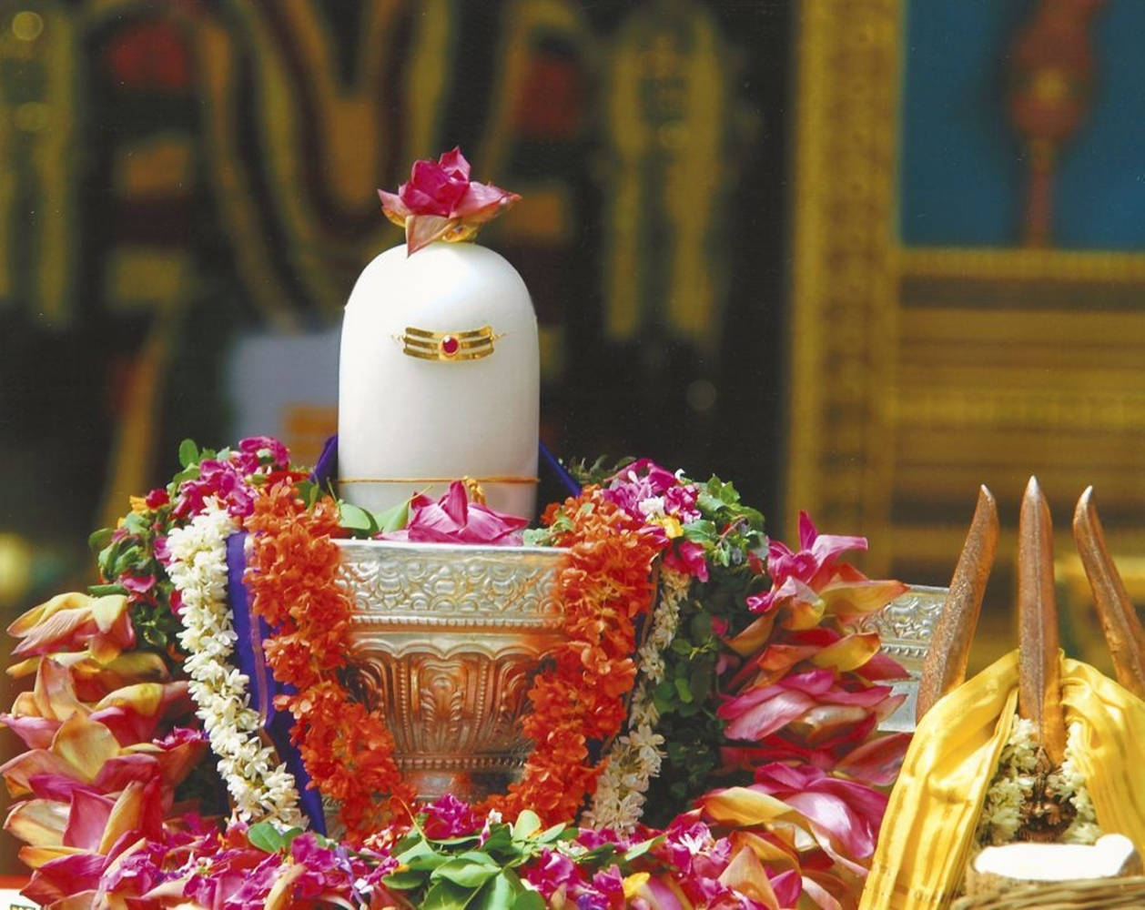 Divine Shiva Lingam Adorned With A Colorful Garland Wallpaper