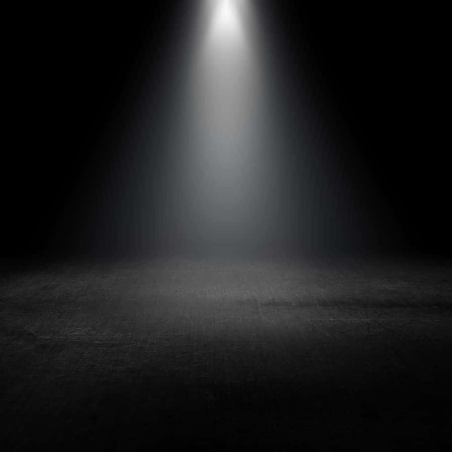 Dramatic Spotlight On A Dark Stage Wallpaper