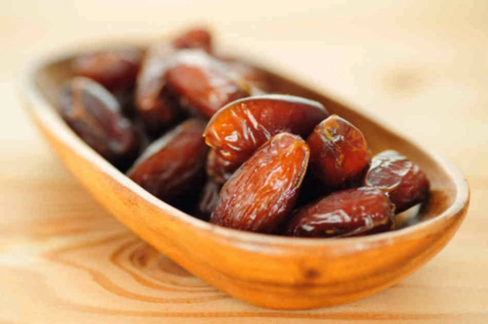 Dried Dates On A Wooden Plate Wallpaper