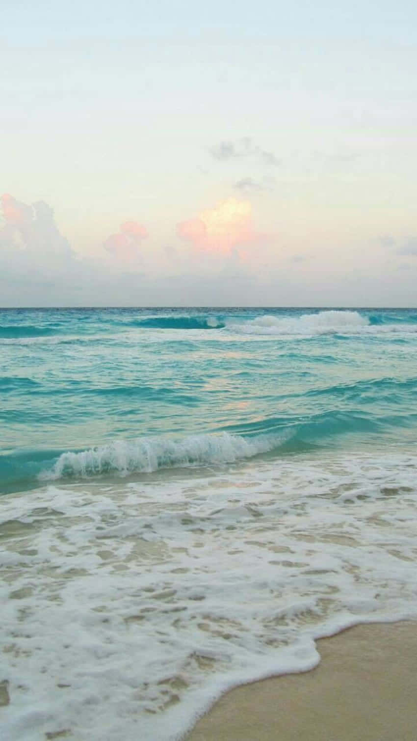 Embrace The Beauty Of A Tranquil Beach Day. Wallpaper