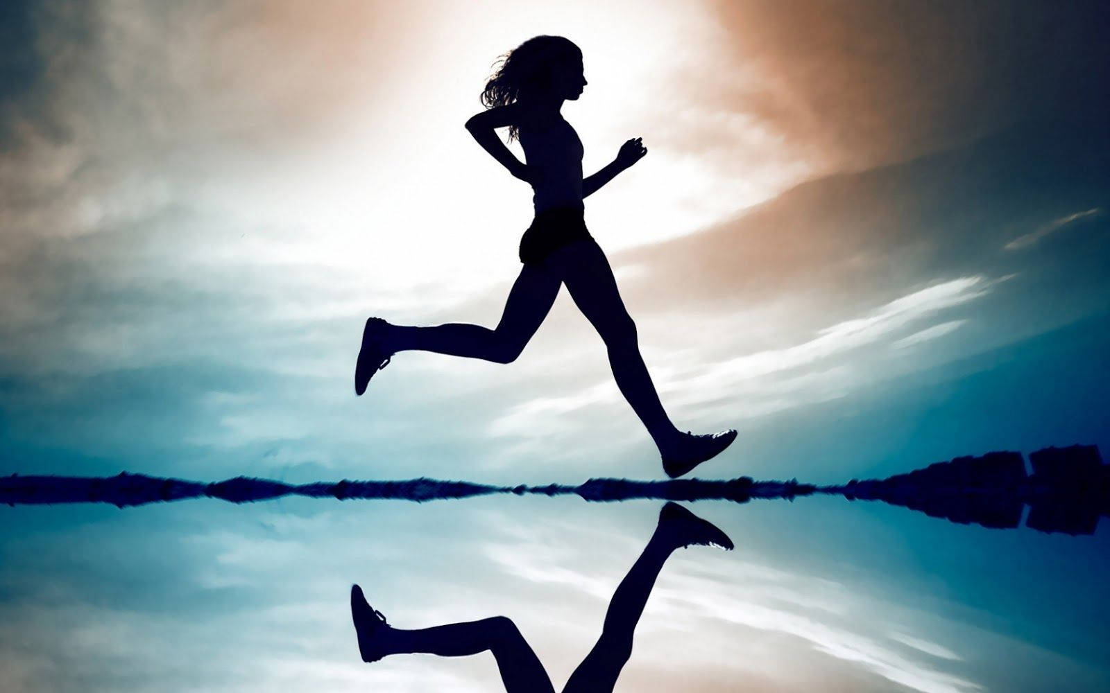 Empowered Woman Running In The Sunshine For Physical Therapy Wallpaper
