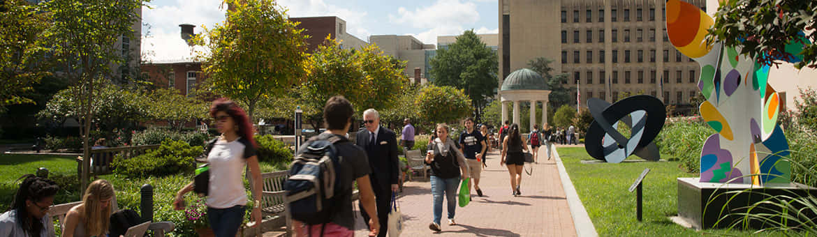 Energized Students Walking Across The Campus Of George Washington University Wallpaper