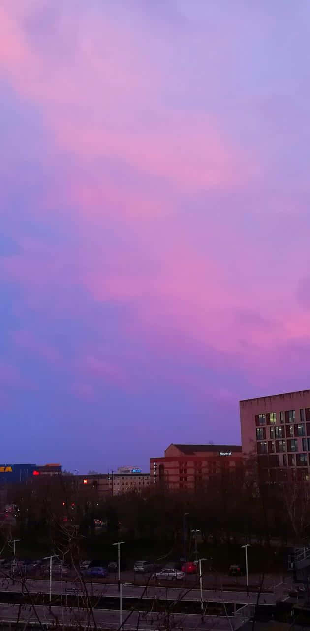 Enjoy The Colorfully Illuminated City During A Sunset Wallpaper