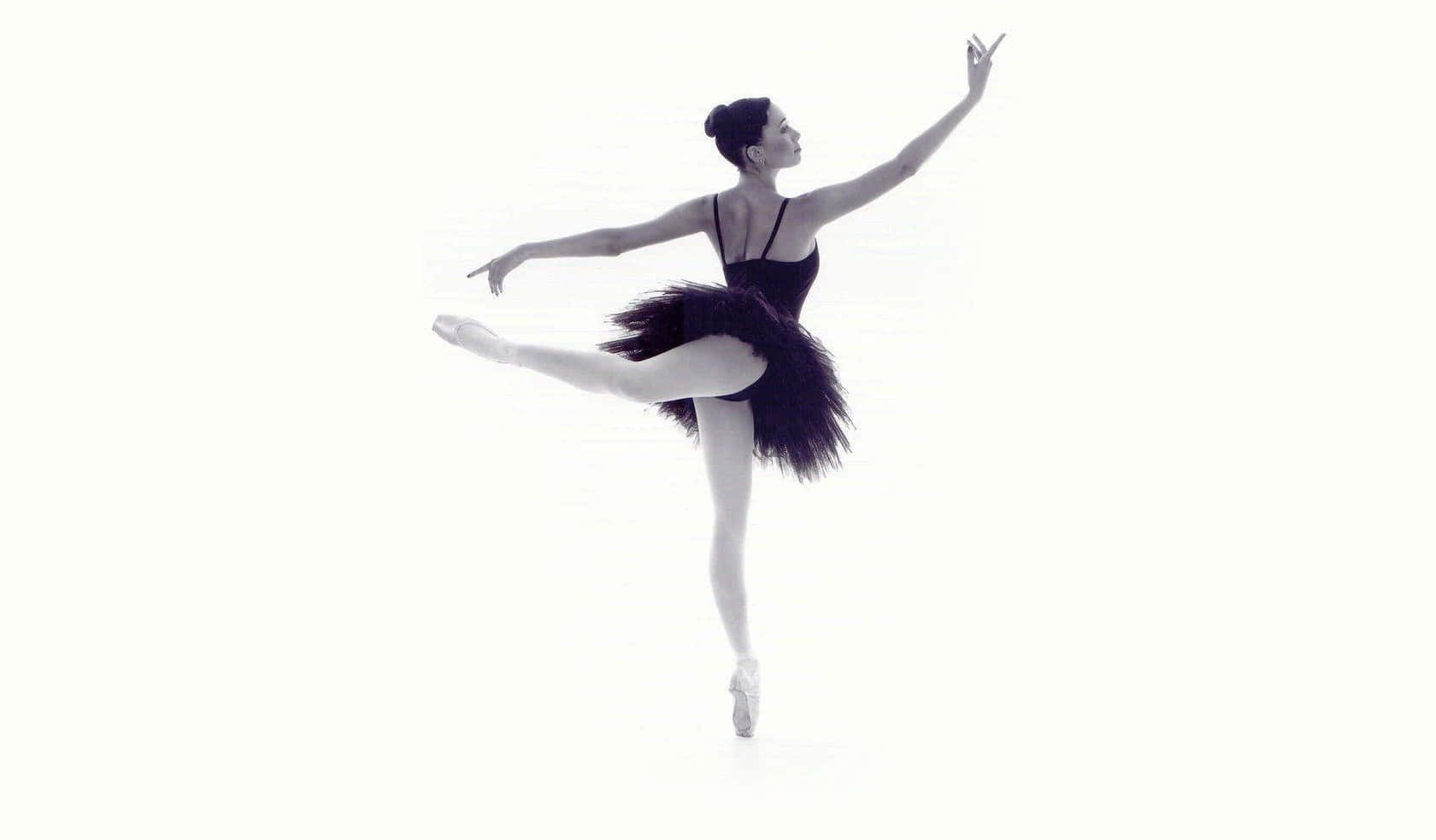 Enthralling Black And White Image Of Ballerina In Arabesque Pose Wallpaper