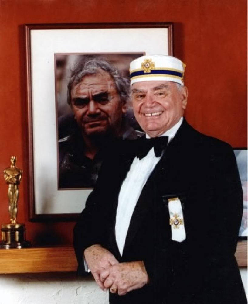 Ernest Borgnine With His Framed Portrait Wallpaper