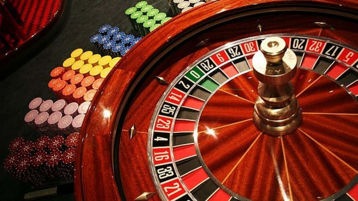 Exciting Spin Of Fortune - Roulette Wheel And Betting Chips Wallpaper