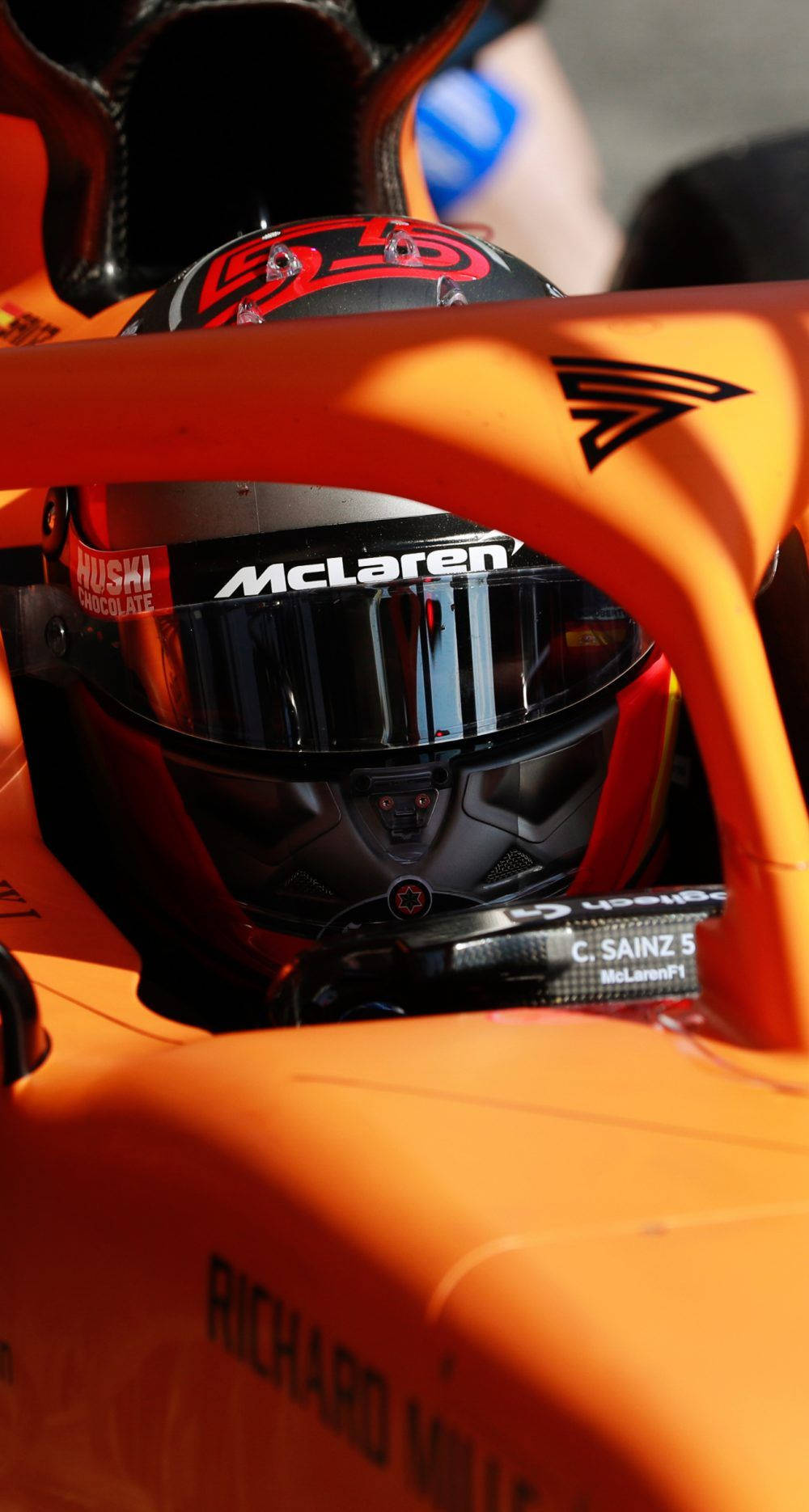 F1 Star Daniel Ricciardo Equipped With His Helmet In His Racing Vehicle Wallpaper
