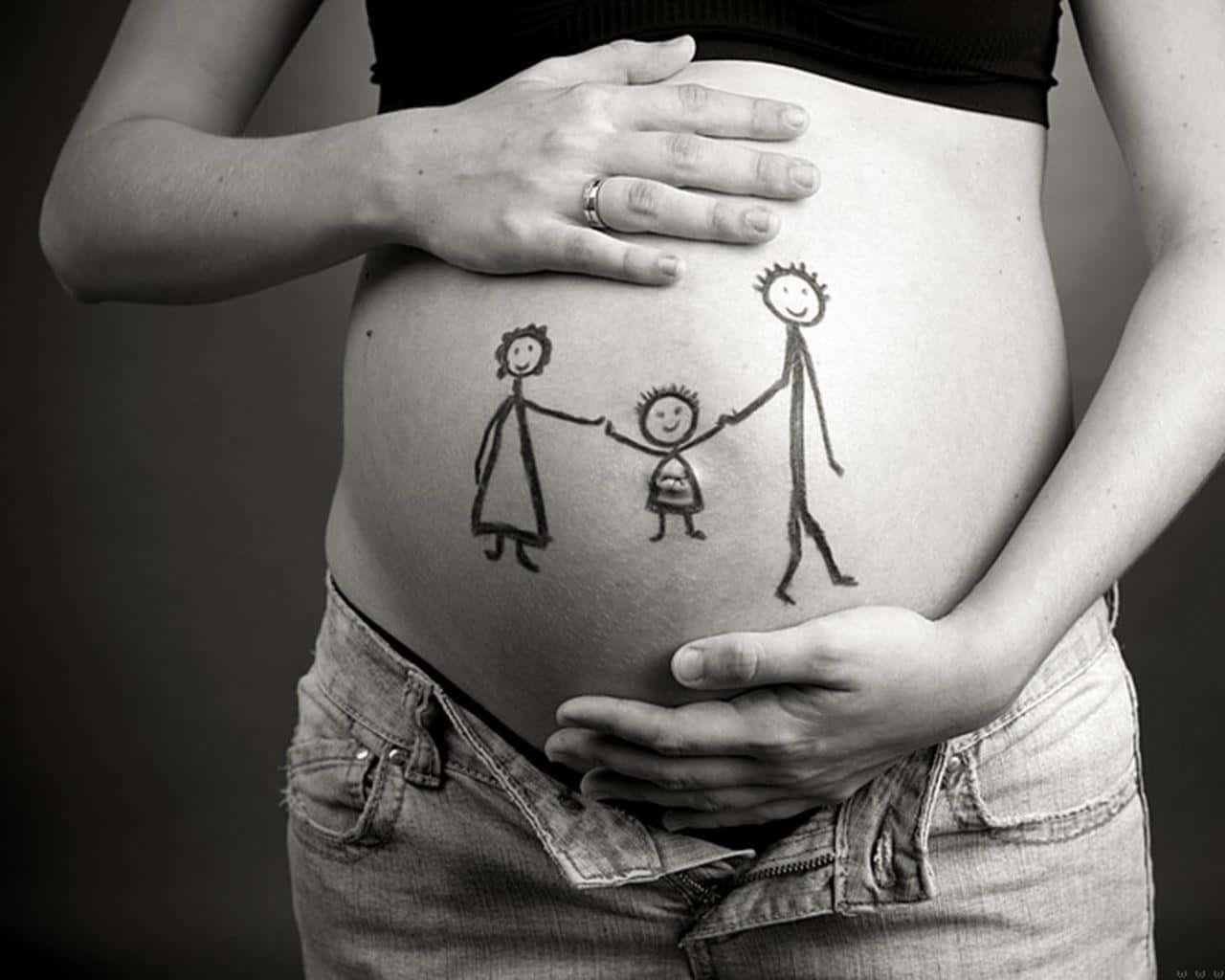 Family Celebrating Pregnancy With Belly Painting Wallpaper