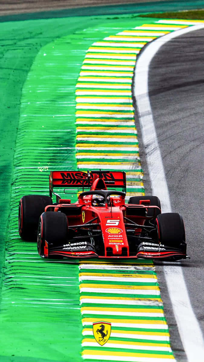 Ferrari F1 Car Driving Down A Track Wallpaper