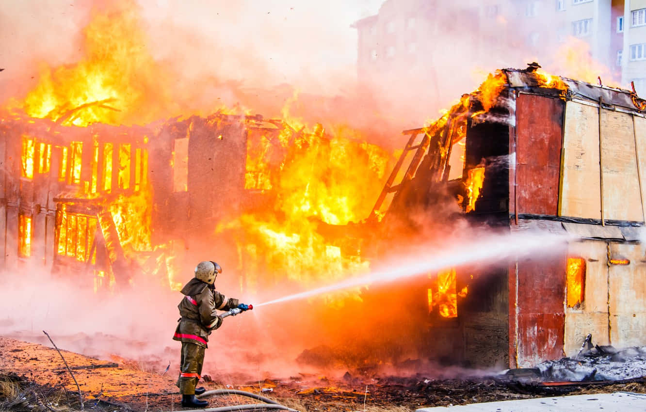 Fire Department Officer On A Flaming Complex Wallpaper