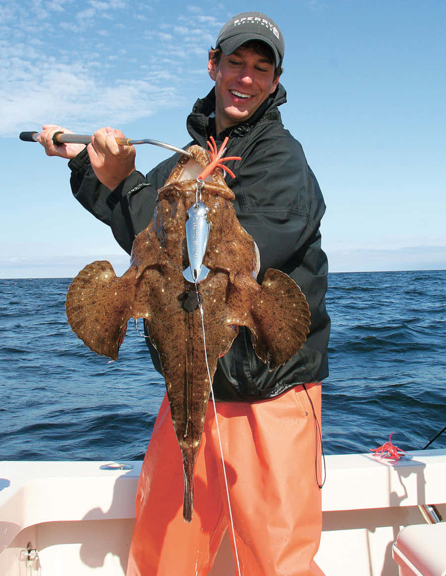 Fisherman Holding Caught Monkfish Wallpaper