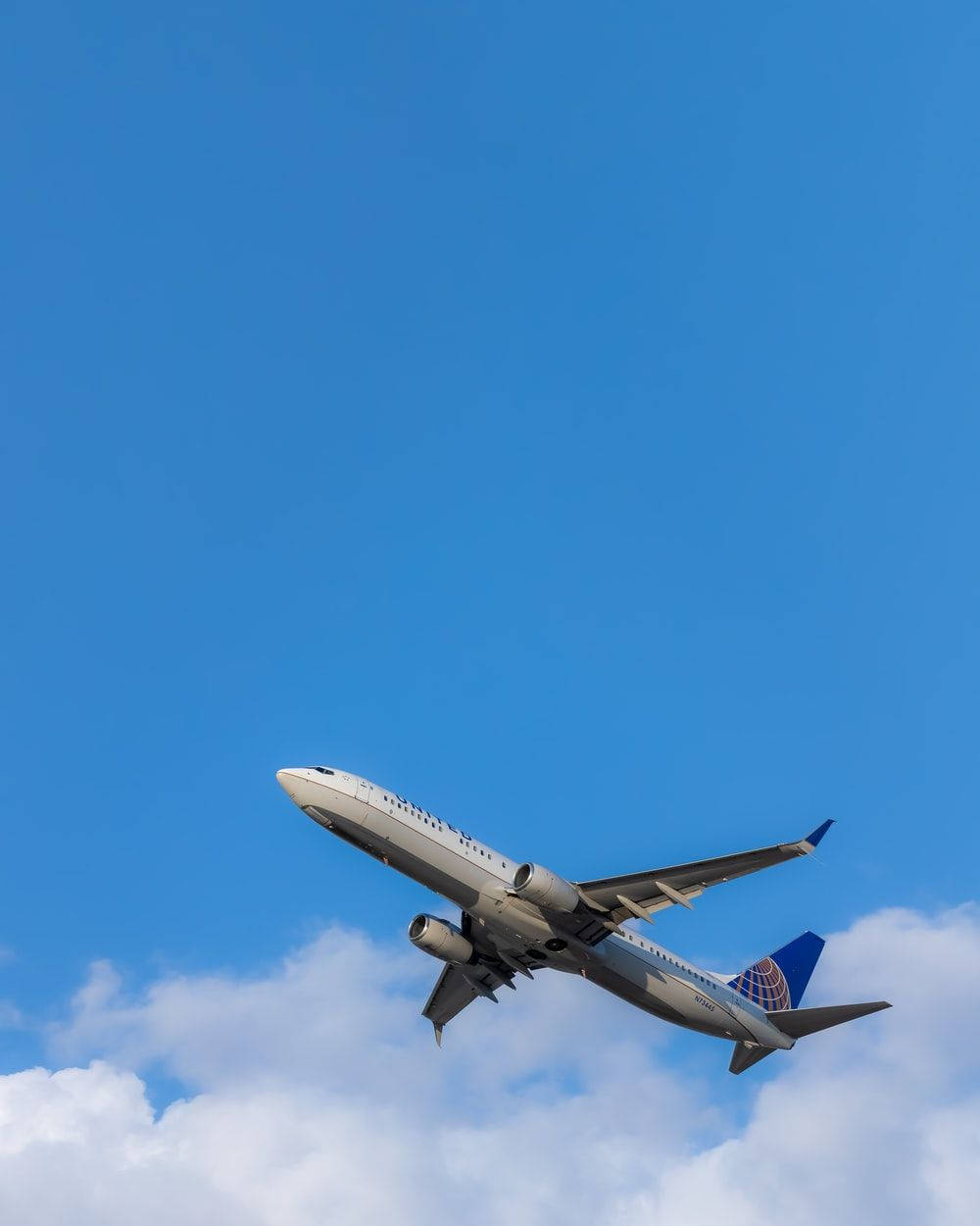Flying White And Blue Airplane Android Wallpaper