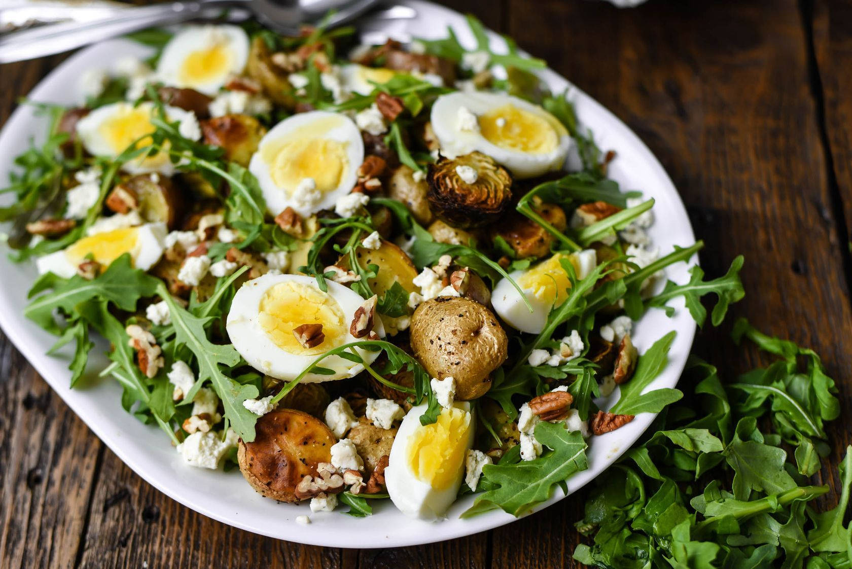 Fresh Arugula, Eggs, And Potatoes Salad On A Rustic Table Wallpaper