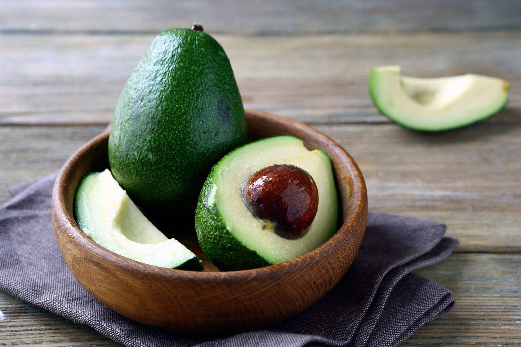 Fresh Avocado Fruit On Wooden Plate Wallpaper