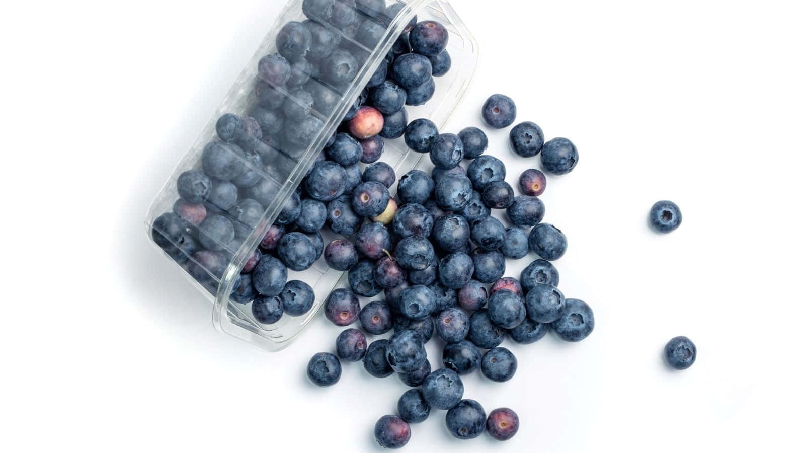 Fresh Blueberries Spilled From Container Wallpaper