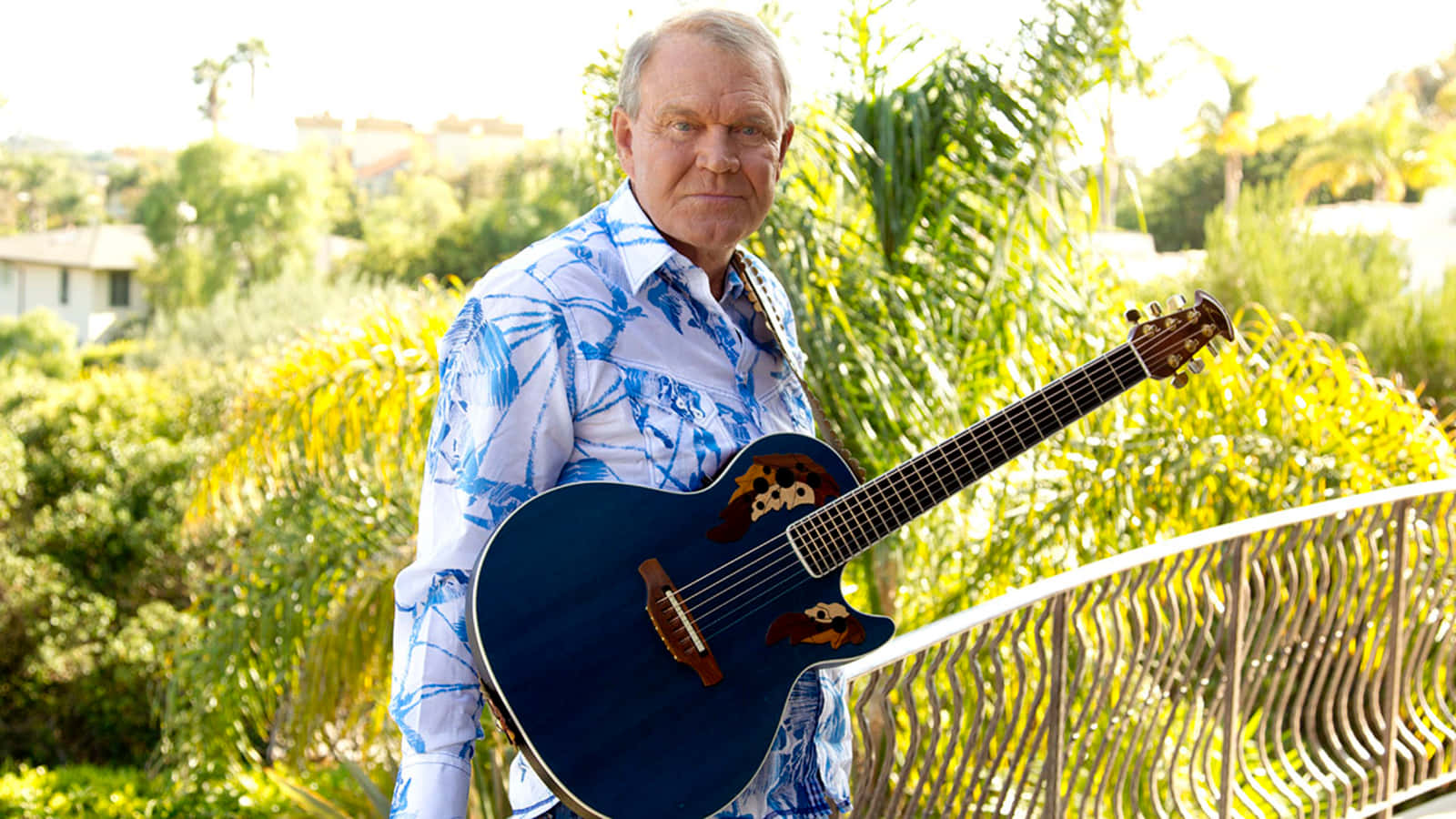 Glen Campbell Holding Guitar Outdoors Wallpaper