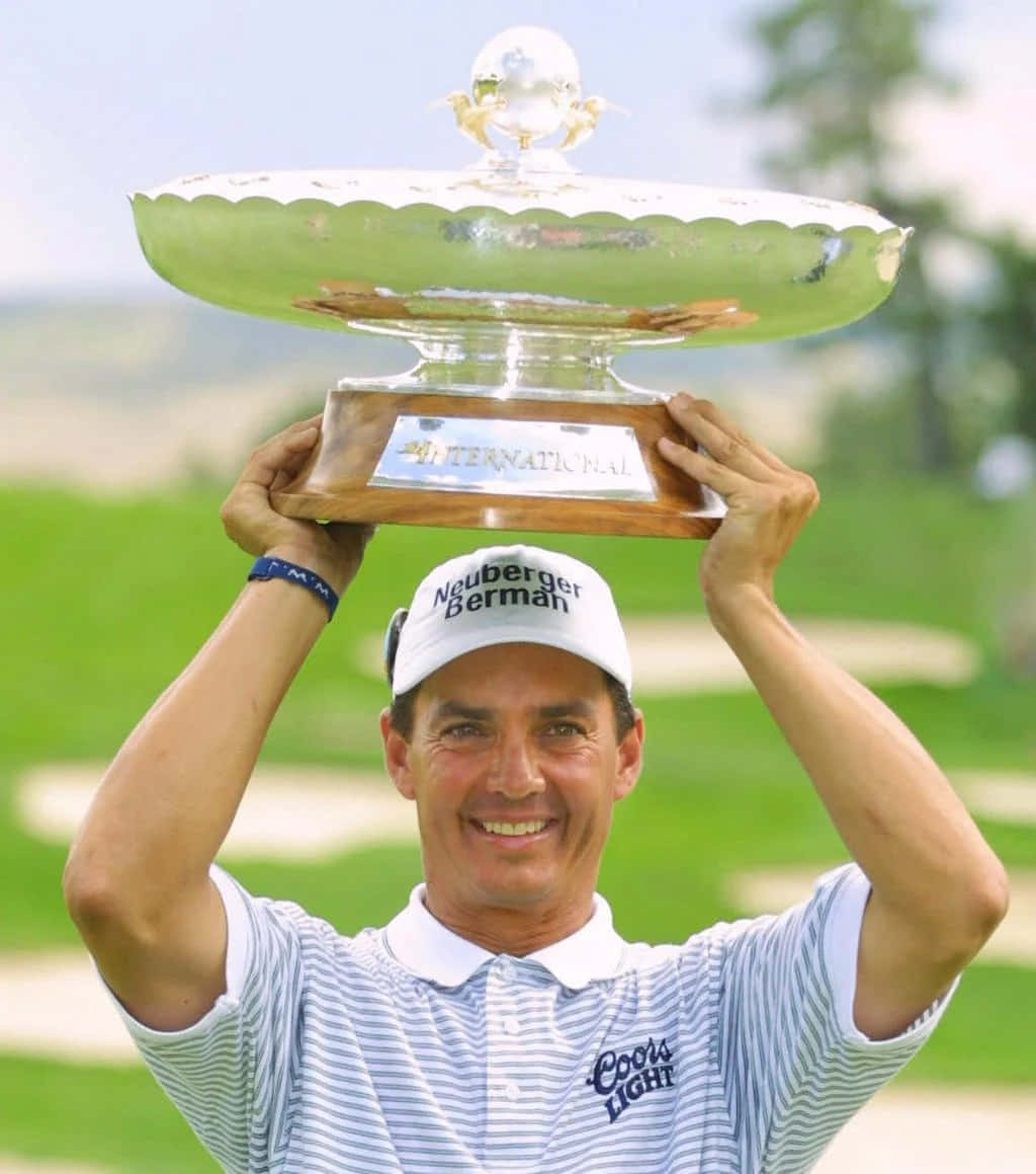 Golfer Celebrating Victorywith Trophy Wallpaper