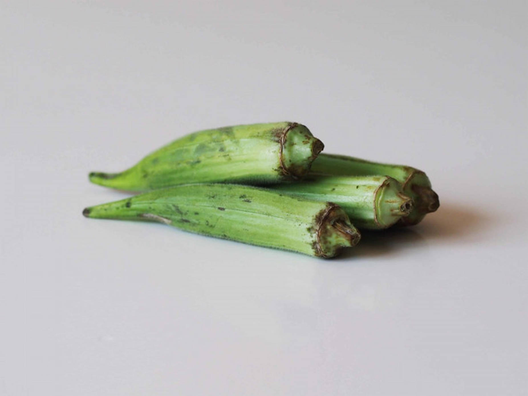 Green Okra On White Table Wallpaper