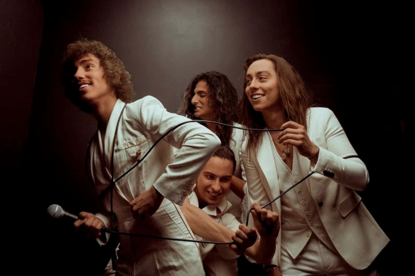 Greta Van Fleet Rocking Out In A Dynamic Stage Display Wallpaper