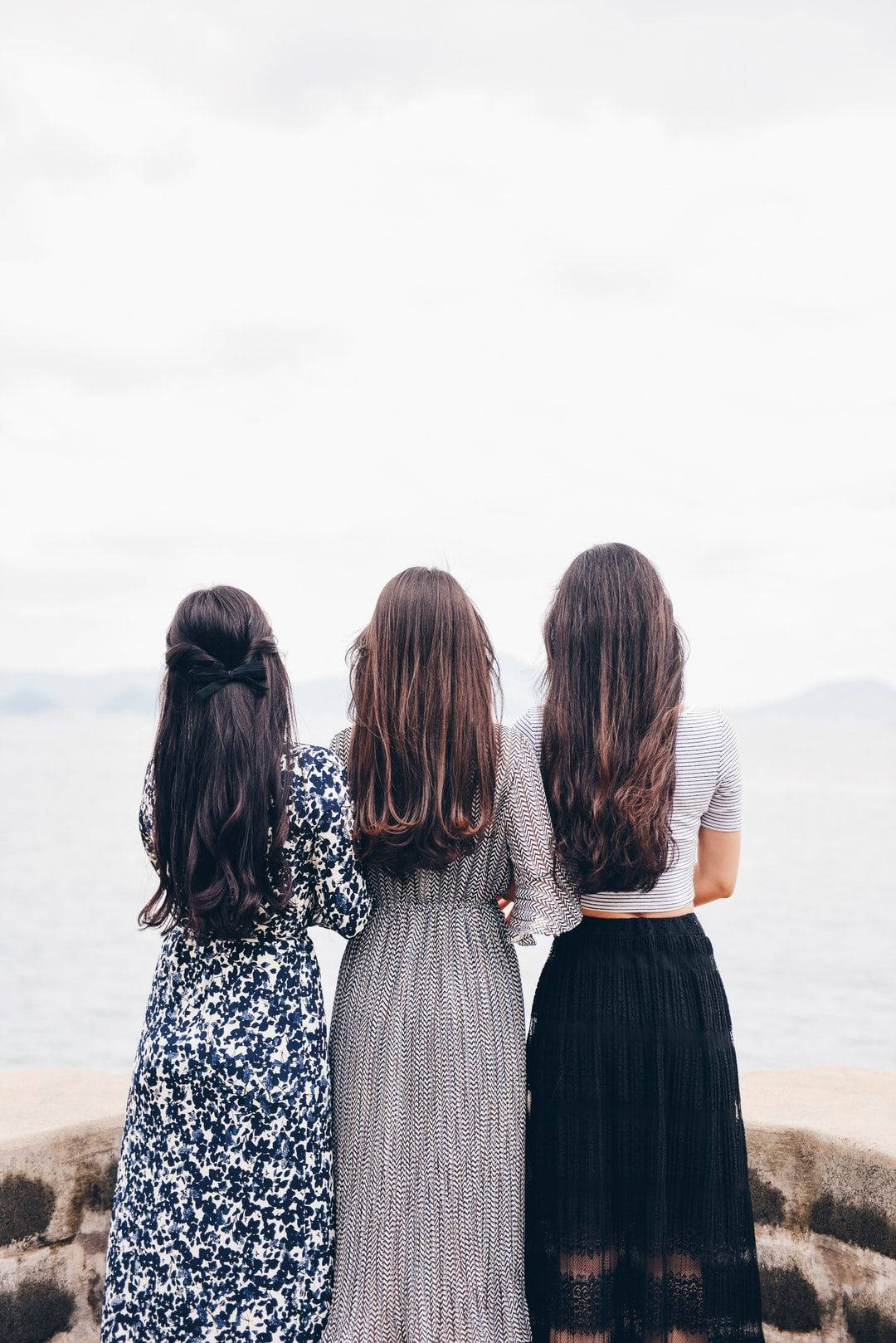 Group Of Girls With Backs Turned Wallpaper