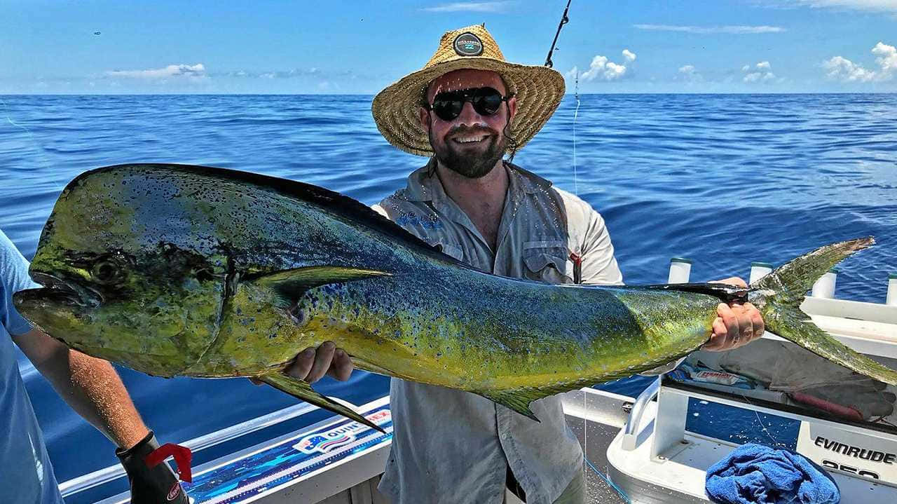 Happy Anglerwith Caught Mahi Mahi Wallpaper