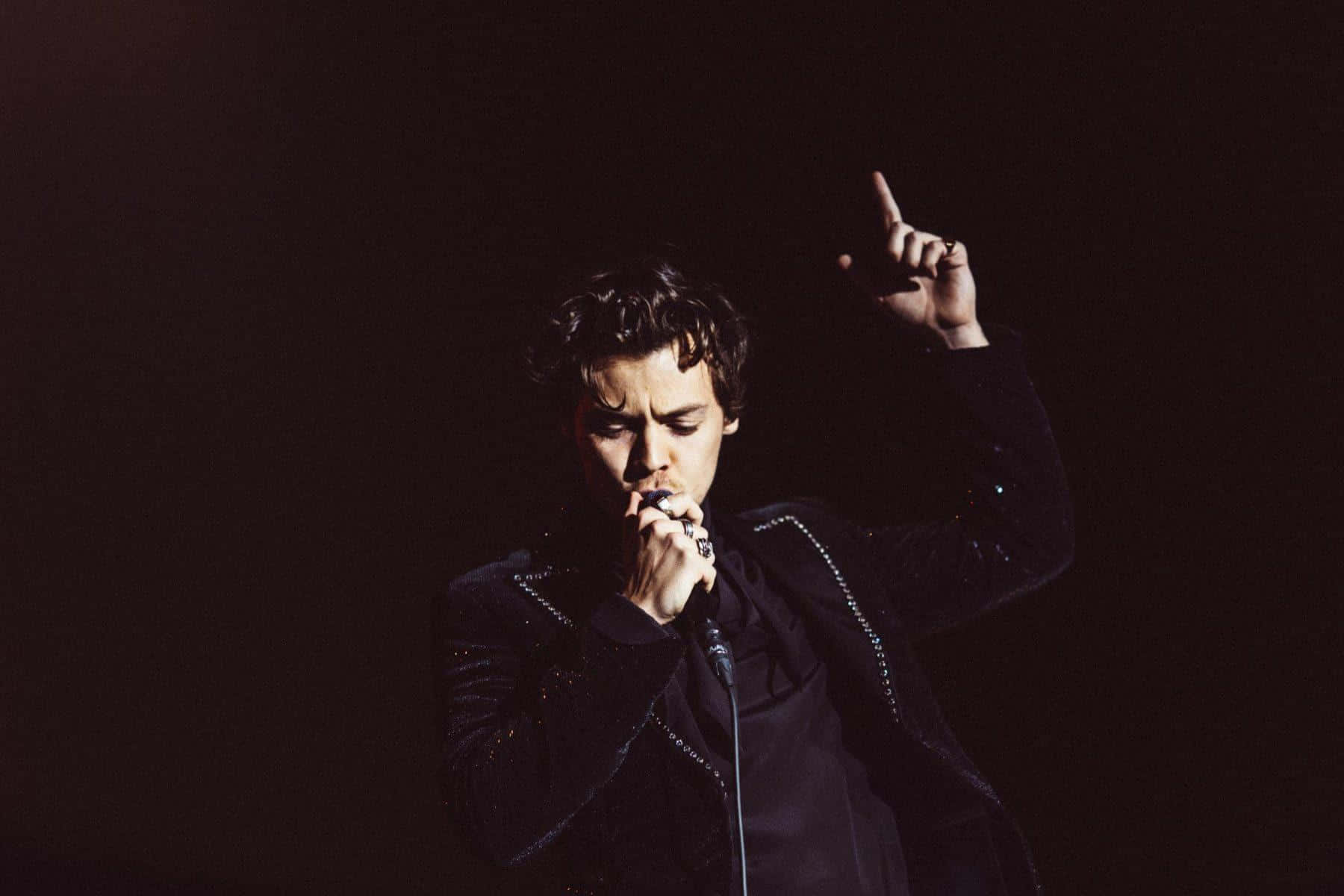 Harry Styles Relaxes With His Laptop Wallpaper