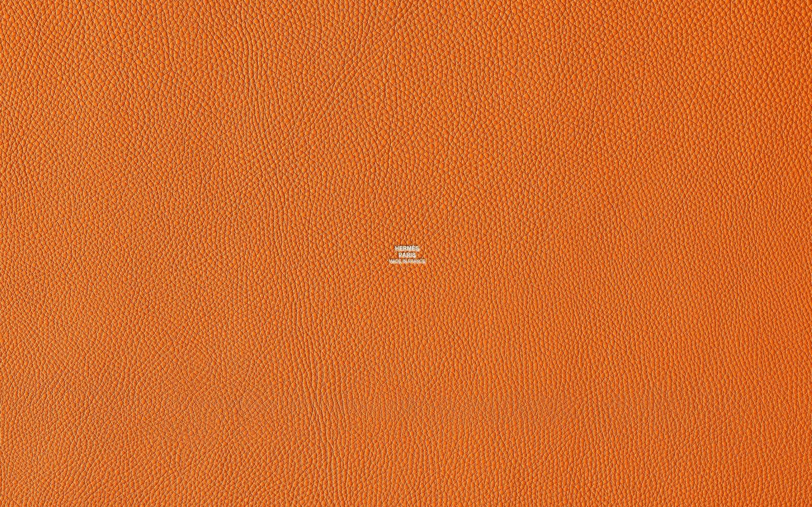 Hermes Logo On Textured Orange Background Wallpaper