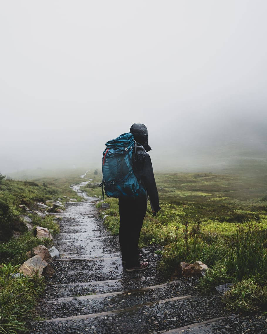 Hiker Under The Rain Travel Laptop Wallpaper