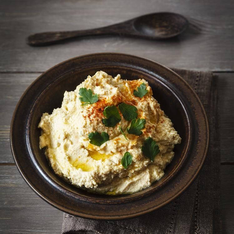 Hummus In Black Bowl With Black Spoon Wallpaper