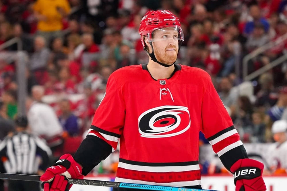 Ice Hockey Superstar Dougie Hamilton Celebrating Victory To Cheering Crowd Of Carolina Hurricanes Wallpaper