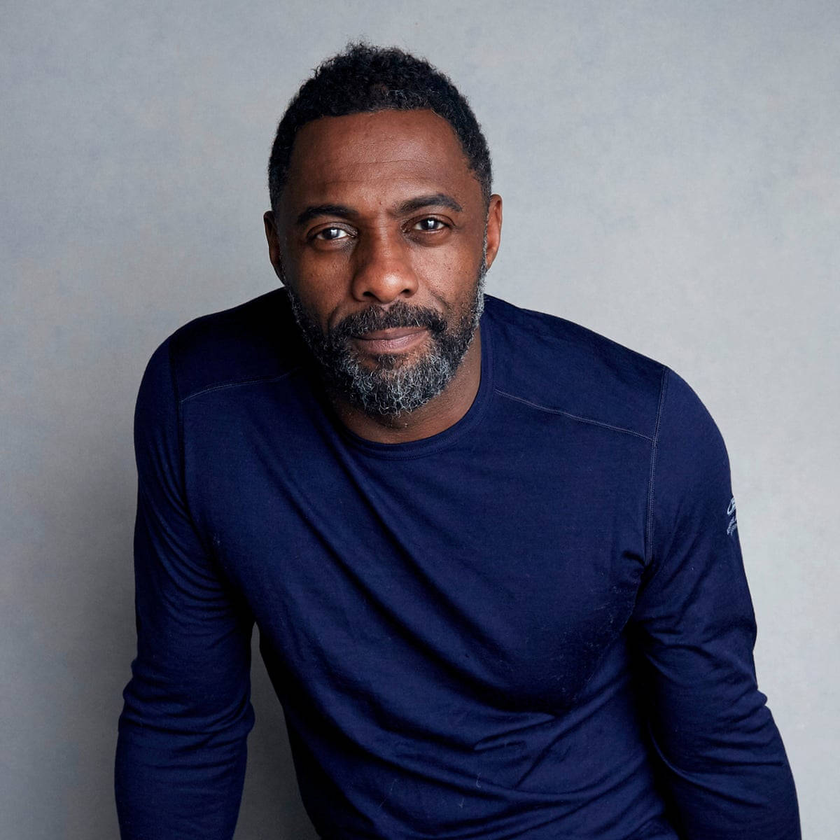 Idris Elba Charming In Blue Sweater Wallpaper